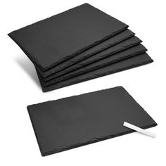 four black slate place mats with a white marker