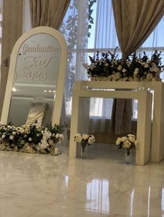 an image of a wedding ceremony setting with flowers on the table and sign in front