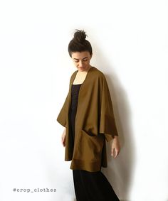 Handmade khaki green boho kimono robe with pockets. Our kimono robe comes in a wide and loose style, one-size-fits all. This is one of our favourite kimono jackets as it is made with a slightly heavier khaki green cotton viscose fabric, giving it a more oversized shirt/ cardigan feel when worn. This is a beautiful simple fabric which creates strong shadows in movement due to its very slight sheen that we are happy shows in the photographs too. Finished with wide arm quarter length sleeves and a Fall Kimono With Relaxed Fit And Kimono Sleeves, Fall Kimono With Relaxed Fit For Loungewear, Chic Fall Kimono For Loungewear, Chic Fall Loungewear Kimono, Oversized Beige Wrap Outerwear, Fall Layering Kimono With Kimono Sleeves, Chic Fall Kimono With Kimono Sleeves, Oversized Casual Kimono For Layering, Beige Casual Kimono With Relaxed Fit