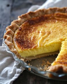 a close up of a pie on a plate with a piece missing from it's crust