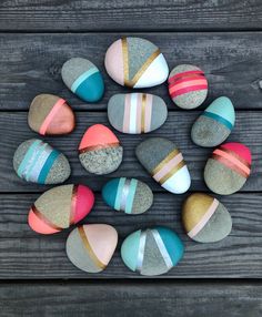 colorful rocks arranged in a circle on top of a wooden table