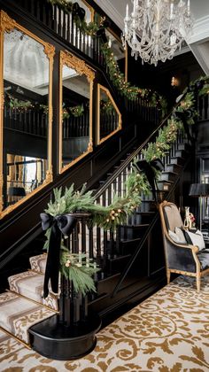 a staircase decorated for christmas with garland and lights