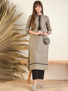 This beige kurta features a unique geometric woven design and intricate thread work details. The mandarin collar and three-quarter roll-up sleeves add a touch of sophistication, while the A-line shape and calf length offer a flattering, regular fit. Made with machine-woven regular cotton, this kurta is both stylish and Western Kurtis, Beige Kurta, White Kurta, A Line Kurta, Eid Collection, Woven Design, Roll Up Sleeves, Kurta Designs, Thread Work