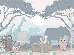 an elephant and giraffe wall mural in a child's room with toys