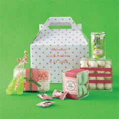 a box filled with lots of candy next to other boxes and items on a green surface