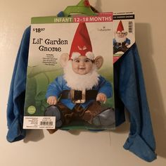 an infant's garden gnome costume hanging on the wall