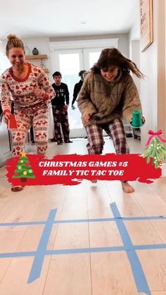 two women are playing with a christmas game on the floor