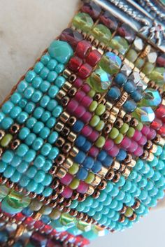 a close up of a bracelet made out of beads