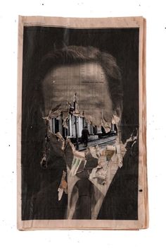 an old torn piece of paper with a man's face and buildings in the background