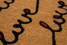 a close up view of a door mat with the word love written in black on it