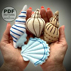 three handmade seashells are in the palm of someone's hands