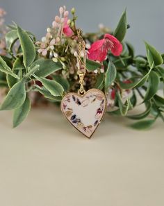 This beautiful floral pendant features real  flowers grown, dried, and pressed by me. The perfect flowers are set in a soft white resin and a gold colored heart bezel. This beautiful pendant comes with a gold chain measuring 20 inches in length. Some very minor imperfections may be noted due to the handmade nature of this product. Do not wear jewelry piece showering or swimming to keep it looking its best. Soft White Background, Background Gold, Floral Pendant, Bezel Pendant, Growing Flowers, Colorful Heart, Gold Heart, Real Flowers, Flower Petals