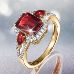 An exquisite ring, crafted from sterling silver, finished in 18k yellow gold. At the heart of this masterpiece is a stunning emerald – cut Garnet, a gem known for its deep, rich color and timeless allure. Embraced by a halo of Diamondeau®, flawless simulated diamond, the center Garnet is elevated to new heights, creating a luminous focal point that radiates grace and charm. Adding to the allure, two additional Garnets grace the sides of the ring, seamlessly integrating with the design to enhance the overall brilliance. A stunning ring that is the testament to the beauty found in every detail. Ladies Ring, Latest Jewellery, Signature Design, Emerald Cut, Rich Color, Time Piece, Focal Point, Women Rings, Garnet