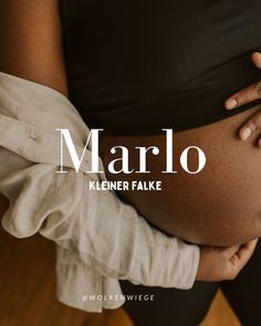 a pregnant woman holding her belly with the words marlo in white on top of it