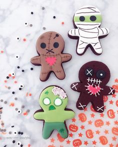 three decorated cookies sitting on top of a table