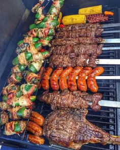 several skewers of meat and vegetables are being cooked on an outdoor bbq