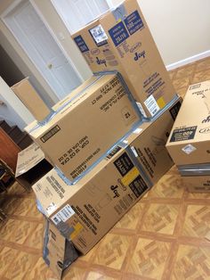 several boxes stacked on top of each other in the middle of a living room floor