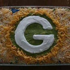 a casserole dish with cheese and cream in the shape of a letter g