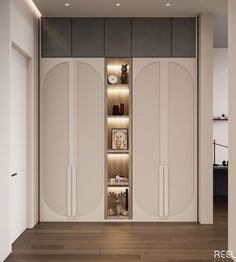 an open closet in the middle of a room with wooden floors and white walls, lighted by recessing lights