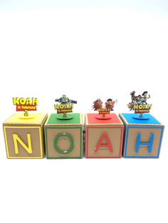 three wooden blocks spelling the word noah with toy animals and letters that spell out noah