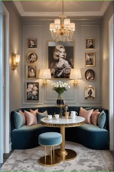 a living room with blue couches and pictures on the wall above it, along with a round coffee table