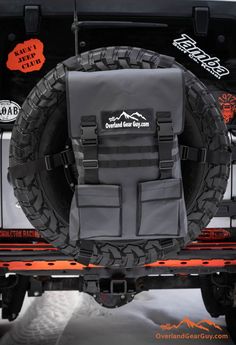 the back end of a jeep with an off road tire cover