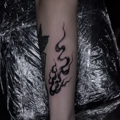 a black and white photo of a woman's leg with a tattoo on it