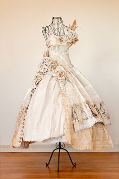 a dress made out of old clothing on a stand