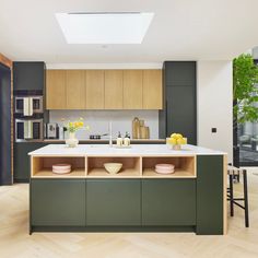 a kitchen with wooden floors and green cabinets