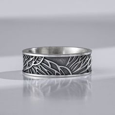 a silver ring sitting on top of a table