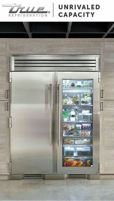 a stainless steel refrigerator freezer with its door open and the words unrivalled capacity above it