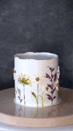 a white cake with flowers painted on it