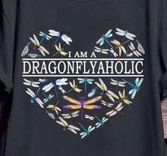 i am a dragonflyaholic t - shirt on display in front of a wall