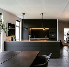 an open kitchen and dining room area in a modern home