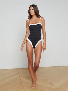 The one-piece swimsuit has never looked so chic. Bold contrast trim lends effortless sophistication and gold button accents add a hint of glamour. • Water safe textured bouclé fabric• Additional layer of lining for shape and support• High leg cut• Removable cups• Adjustable & removable straps | L'AGENCE Tory Bandeau One-Piece Swimsuit In Black/White Dd Swimwear, Mastectomy Swimwear, Denim Jacket Short, Maternity Sleepwear, Bandeau One Piece Swimsuit, Knit Denim, Striped Swimsuit, Maternity Swimwear, Tankini Swimsuits