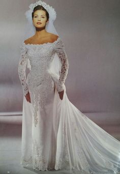 a woman in a white wedding gown and veil