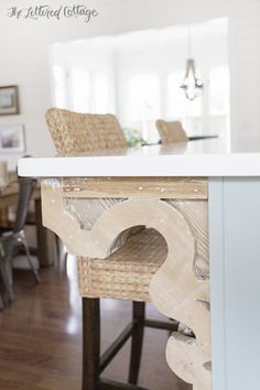 the kitchen island is made from an old piece of wood and has been painted white