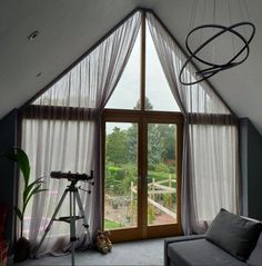 a living room filled with furniture and a large window