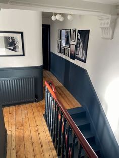 a staircase with pictures on the wall next to it