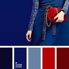 a woman holding a red purse standing in front of a blue wall with color swatches