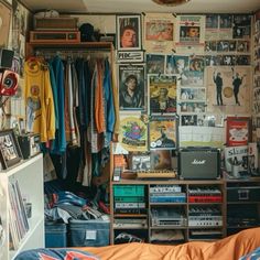 a room filled with lots of different types of items and posters on the wall next to a bed