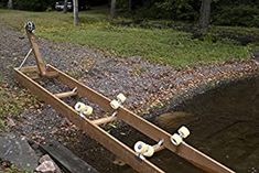 a wooden boat sitting on top of a river