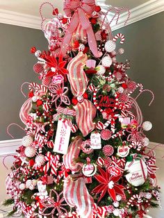 a christmas tree decorated with candy canes and bows