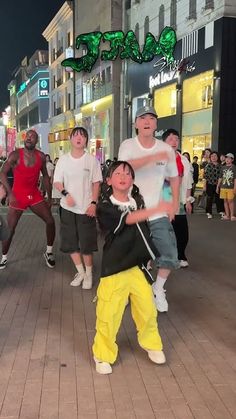 a group of people standing on top of a sidewalk