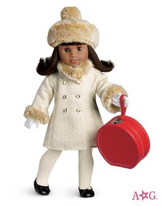 the doll is wearing a white coat and hat with fur on it's head