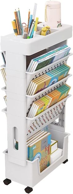 a white cart filled with lots of books and pencils on top of each other