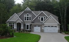 a large house with two garages in front of it