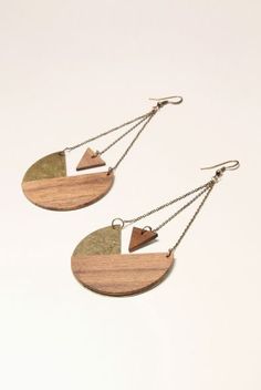 two wooden earrings with chains hanging from them