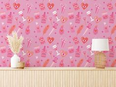 a pink wallpaper with hearts and arrows on it, next to a table lamp