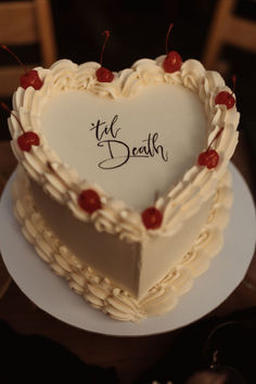 a heart shaped cake with writing on it